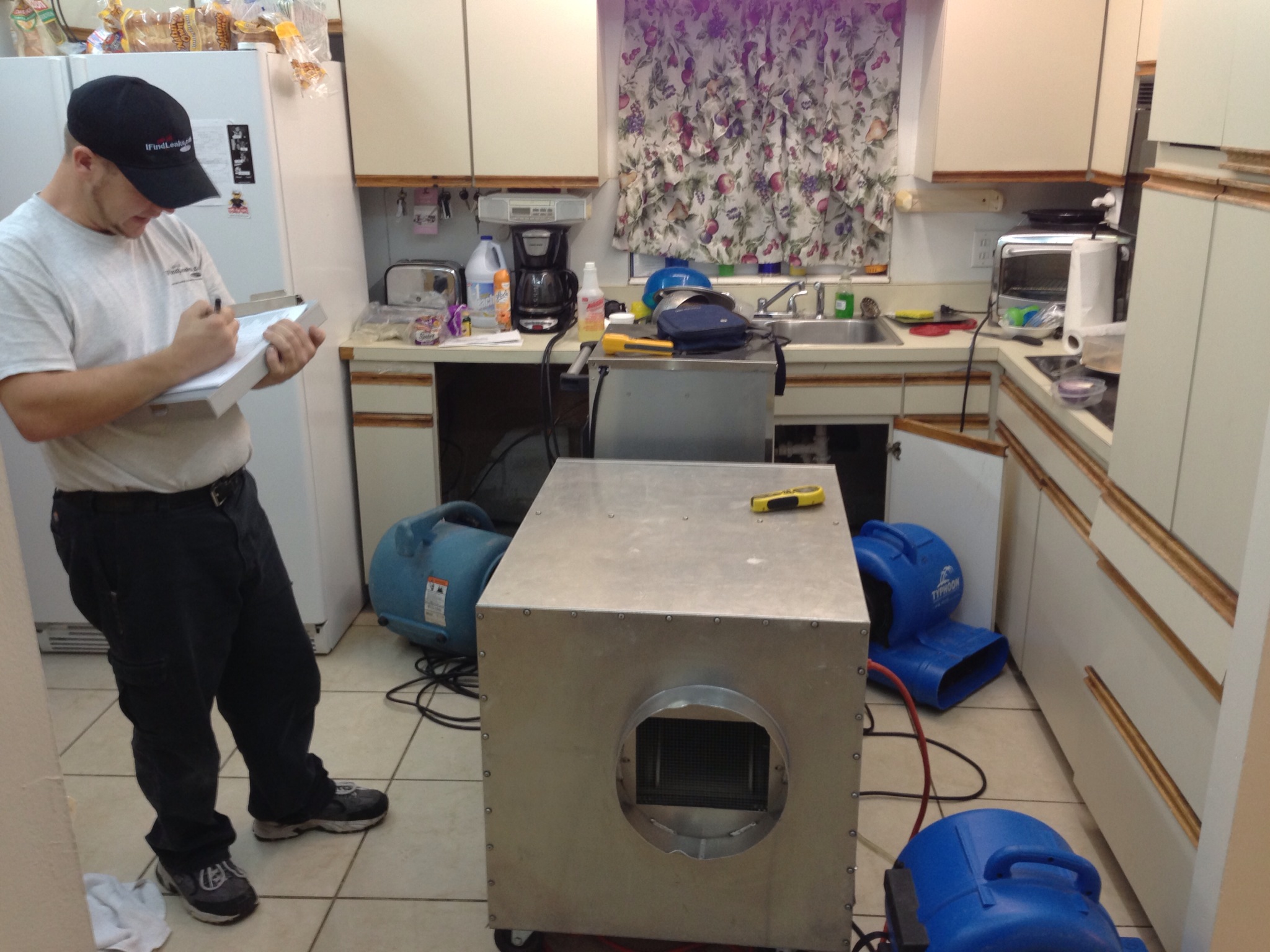 Water damage behind kitchen cabinets in a Tampa home